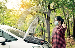 young woman calls insurance while the car is broken