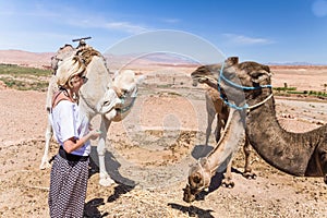 Young woman with a camels in Morocco.