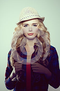 Young woman with camera. Blonde in a plaid shirt. Hipster fashion photographer girl. Young people, youth culture