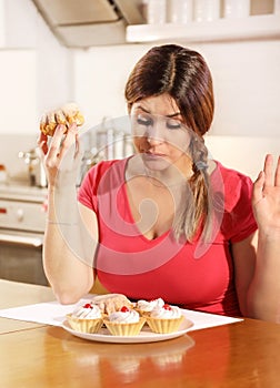 Young woman can not resist the temptation to eat a cake