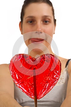 Young woman can't wait to lick lollipop