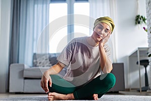 Young woman with cancer resting after taking yoga.