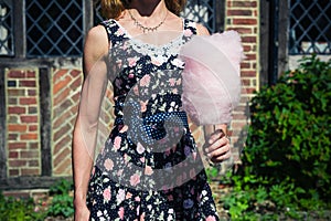 Young woman with candyfloss outside