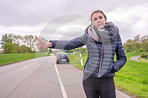 Young woman with a car breakdown wants to hitchhike