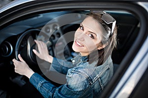 Young woman in car going on road trip.Learner driver student driving car.Driver license exam