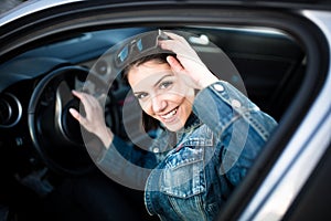 Young woman in car going on road trip.Learner driver student driving car.Driver license exam