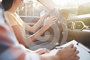 Young woman in car with instructor, closeup. Driving school