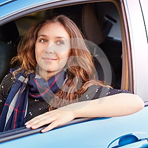 Young woman in car. Ride instruction. Automobile loan