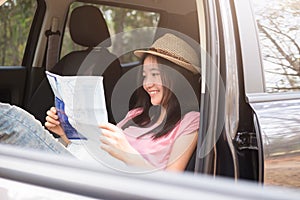 Young woman car traveler with map.