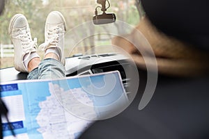 Young woman car traveler with map