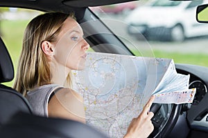 Young woman car traveler with map