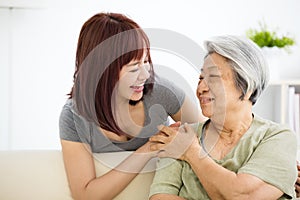 Young woman carefully takes care of old woman