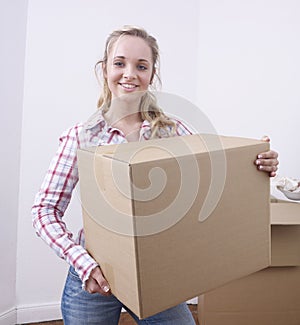 Young woman carrying box