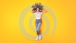 Young Woman In Casual Wearing Wireless Headphones Over Yellow Background