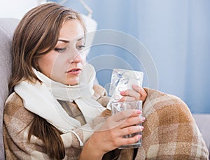 Young woman catching cold taking medication