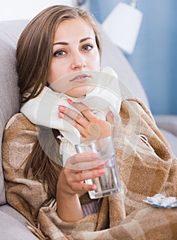 Young woman catching cold taking medication