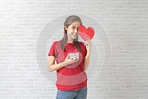Young woman catching Valentine Hearts and gift box. Love concept. Valentines day