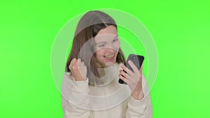 Young Woman Celebrating on Smartphone on Green Background