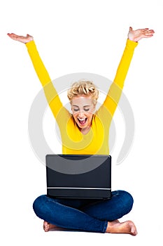 Young Woman Celebrating Success on Laptop