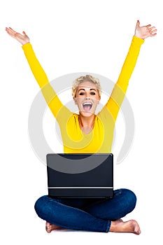 Young Woman Celebrating Success on Laptop