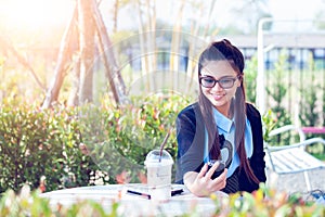 Young woman with cellphone in backyard