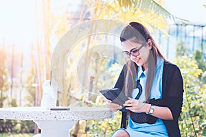 Young woman with cellphone in backyard