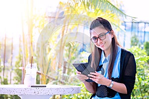 Young woman with cellphone in backyard