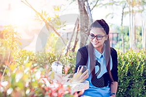 Young woman with cellphone in backyard