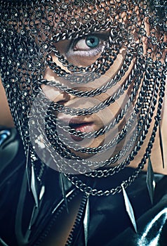 Young woman with chain mask