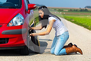 Young Woman Changing Tire