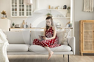 Young woman chatting on-line using tablet digital