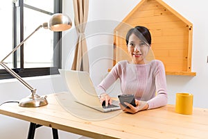 Young Woman check text message when using the computer