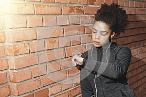 Young woman checking activity tracker