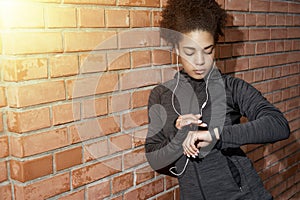 Young woman checking activity tracker