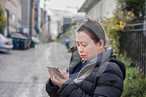 Young woman checking her messages her mobile phone