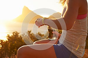 Young woman checking her sports watch