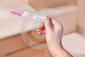 Young woman checking pregnancy test