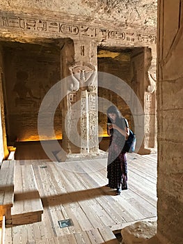 Young Woman Checks Her Phone Inside Temple of Nefertari, Abu Simbel, Egypt