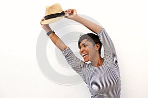 Young woman cheering with arms raised