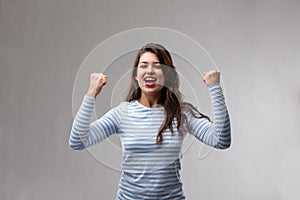 Young woman cheering in exultation