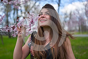 Young woman with cherry trees in bloom