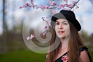 Young woman with cherry trees in bloom