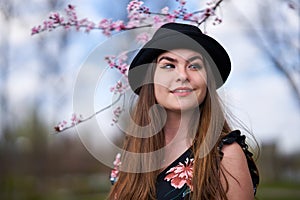 Young woman with cherry trees in bloom