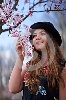 Young woman with cherry trees in bloom