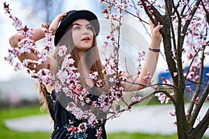 Young woman with cherry trees in bloom