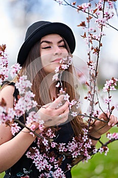 Young woman with cherry trees in bloom