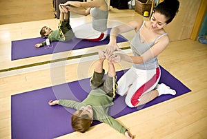 Young woman and child doing Pilates