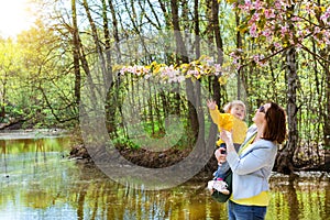 Young woman with child happy Sakura blossom spring