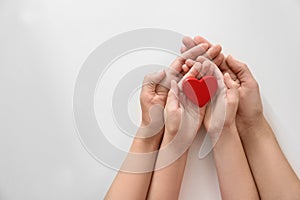 Young woman and child holding red heart