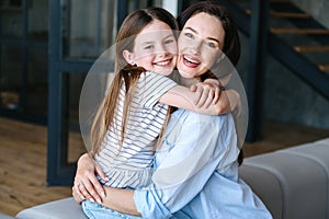 Young woman and child hugging with love, affection, tenderness